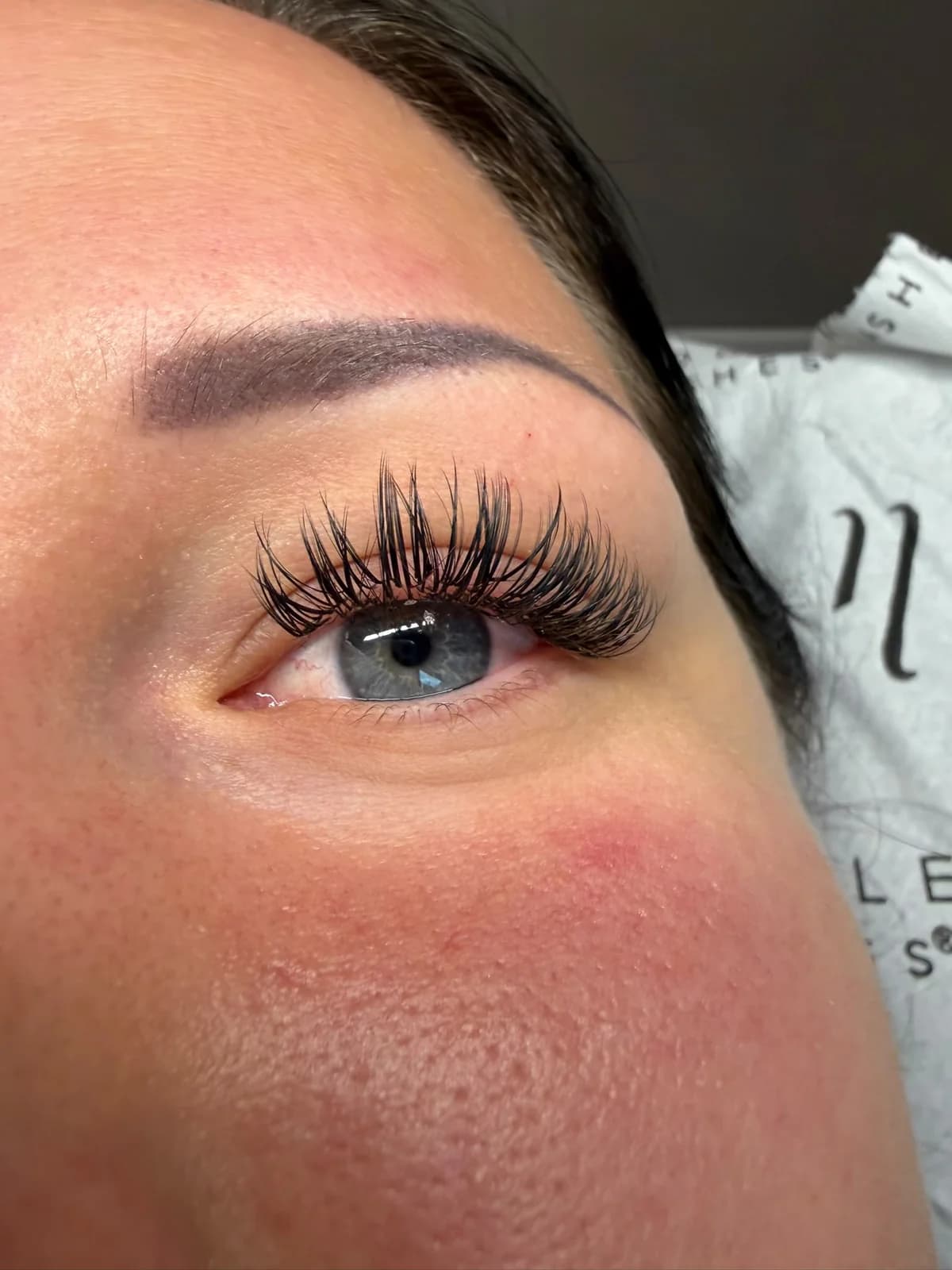 Vanessas Wimpernverlängerung an einem blauen Auge
